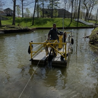 At the controls on the water